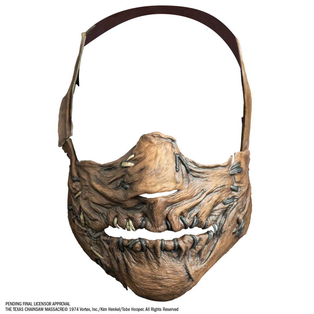 mask, front view.  Lower face only, with strap that goes from cheeks around the back of the head.  lower face wrinkled flesh sewn together at nose, sides of mouth and lips