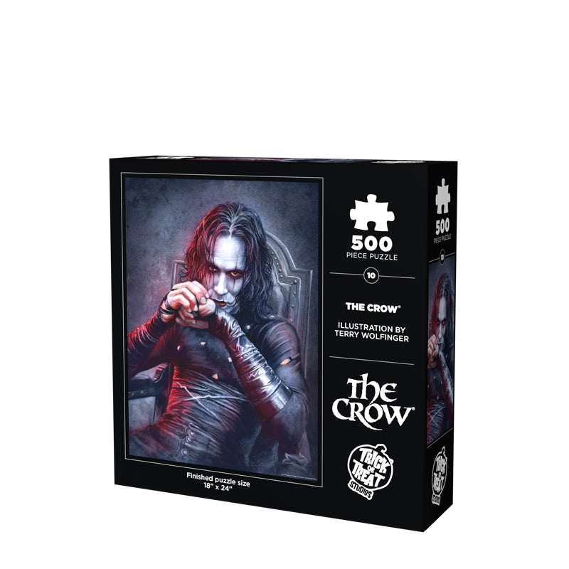 Product packaging. back. Black box, white text reads 500 piece puzzle, The Crow, illustration by Terry Wolfinger, white Trick or Treat Studios logo, finished puzzle size 18 inches by 24 inches. Illustration of Brandon Lee as the Crow, black and white background, upper body of a dark haired man with a pale white face and eye makeup, wearing tattered black skin-tight clothing, sitting in a gray chair.