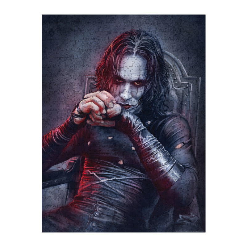 Completed puzzle. Illustration of Brandon Lee as the Crow, black and white background, upper body of a dark haired man with a pale white face and eye makeup, wearing tattered black skin-tight clothing, sitting in a gray chair.