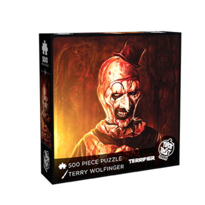 product box, front.  illustration of Art the clown, red, brown and yellow background.  Evil grinning, black and white clown face with blood spatter, high black painted eyebrows, black around eyes and mouth, black dot on tip of nose, wearing tiny black top hat. and blood soaked black and white clown suit. white text below reads 500 piece puzzle, Terry Wolfinger, Terrifier. white trick or Treat Studios logo bottom right 