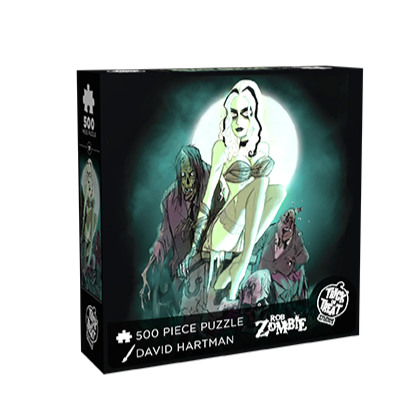puzzle box front. Illustration, background full moon, gray and black sky.  woman, pale green skin, white hair with 2 black stripes, gauze bra and wrap on arms, thigh high stockings, sitting on casket, two zombies behind her, one emerging from the ground in front of her.  white text at bottom reads 500 piece puzzle, David Hartman, Rob Zombie, white trick or Treat Studios logo 