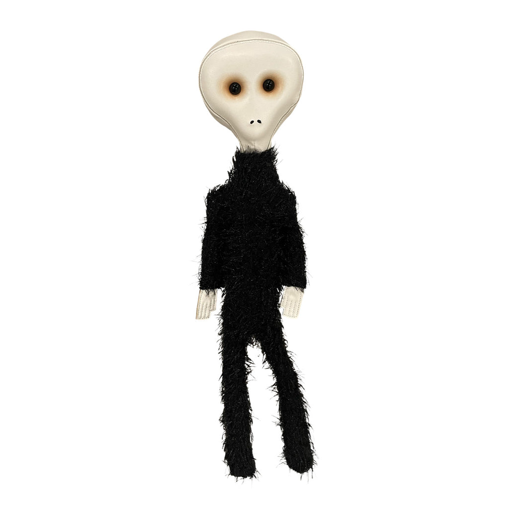 Alien Plush, front view. Tan head large black eyes, small nostrils, no mouth.  Black fur body, bare hands.