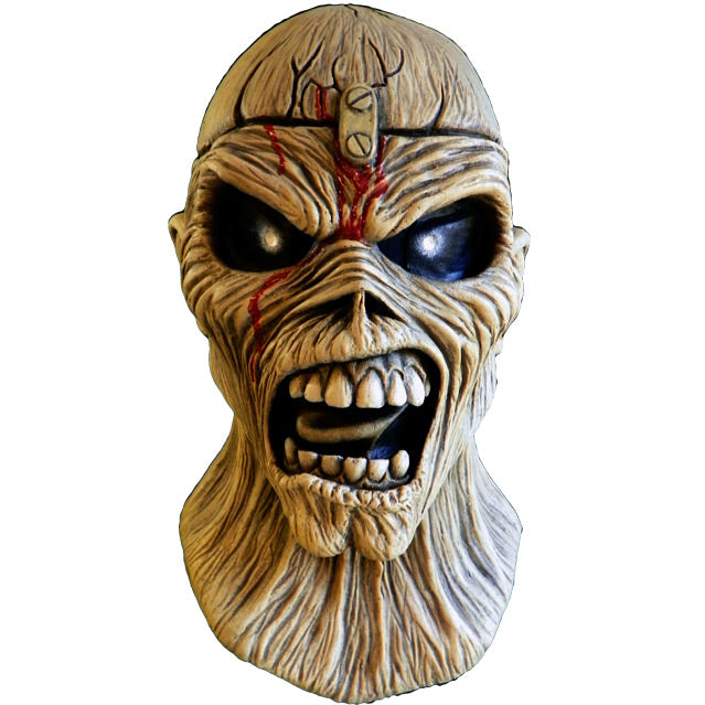 Mask, head and neck, front view. Iron Maiden Eddie, tan, blood coming from middle of forehead large black eyes, open scowling mouth showing teeth.