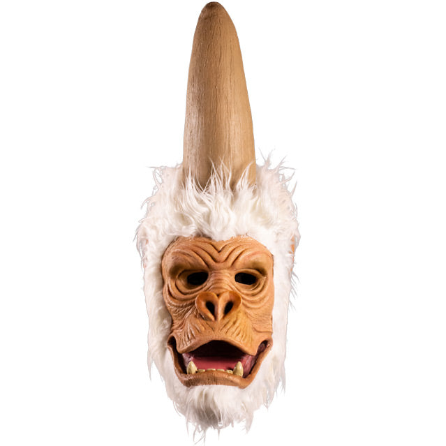 Mask, front view.  Ape-like face, surrounded by white fur, tall elongated upper head that comes to a point.