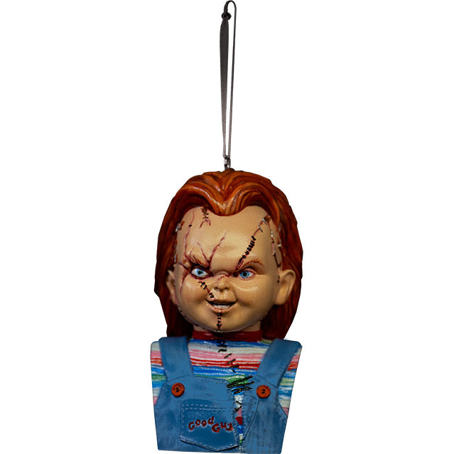 Ornament. Scarred Chucky, head, neck, and chest, red hair, blue eyes, scarred face. Wearing a red, white, blue and green striped shirt, ripped blue overalls with red buttons, red Good Guys printed on pocket.