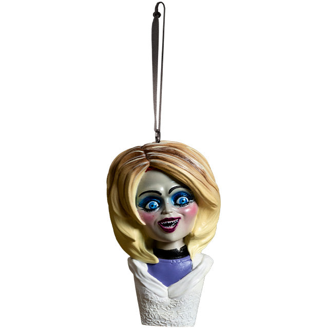 Ornament.  Glenda Bust, head, shoulders and upper chest.  Blond hair, blue eyeshadow, blue eyes, blush and red lipstick, large smile.  Wearing purple shirt with black collar under white wedding dress.  