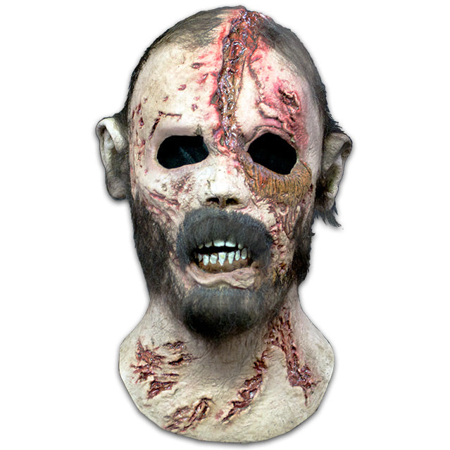 Mask, head and neck. Short black hair.  Pale, damaged flesh, large wound on forehead, many smaller wounds on face and neck.  Full beard, sagging bottom lip.  Mouth slightly open showing brown gums and crooked teeth.