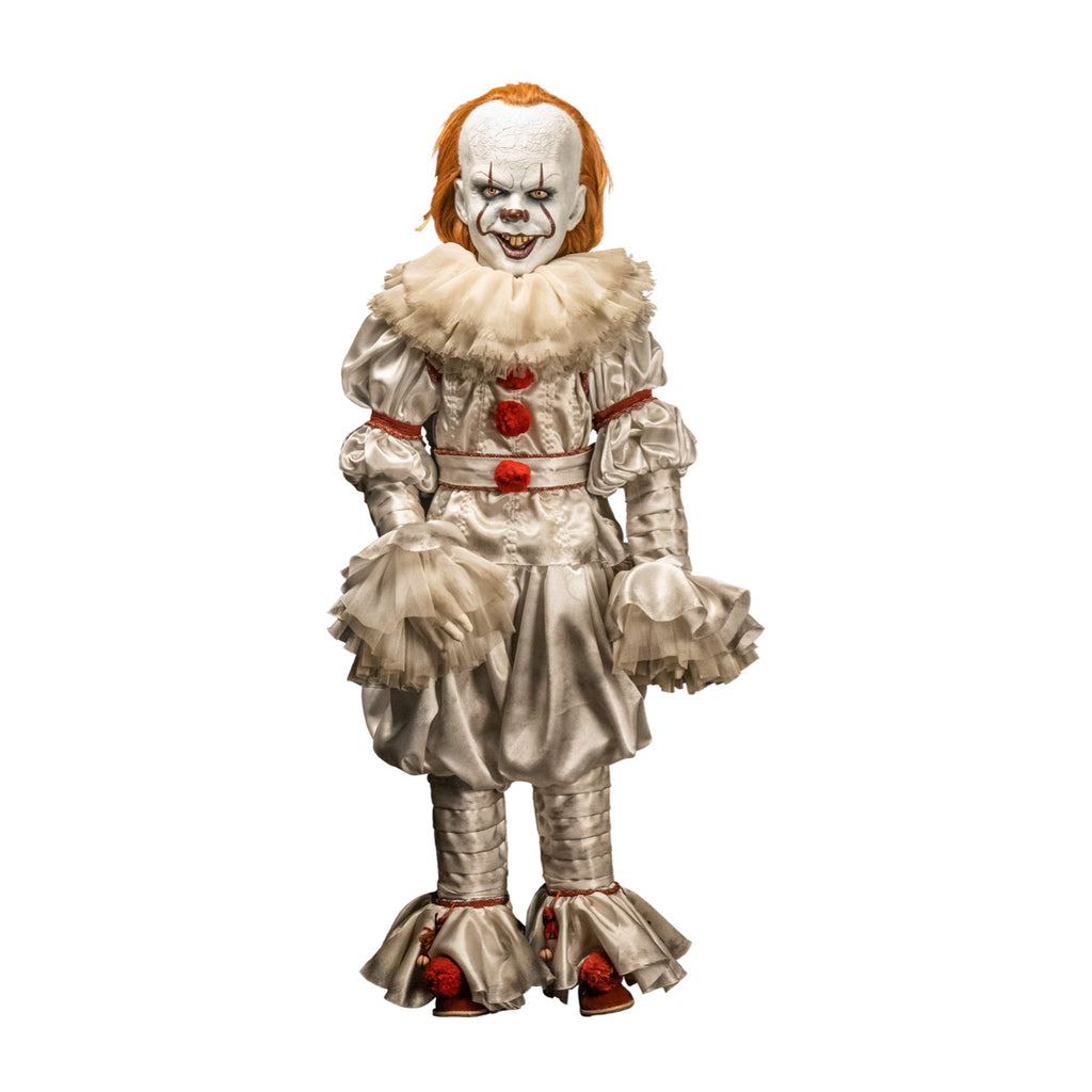 Pennywise doll, front view. clown face, red hair, white skin, large forehead, yellow eyes and nose, dark lips, creepy smile with crooked buck teeth. wearing white and red clown outfit with ruffles at collar and cuffs, red shoes. 