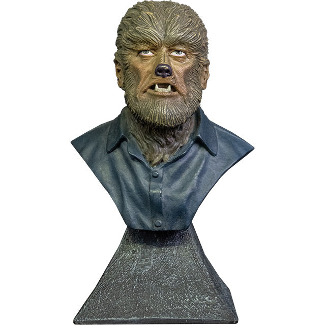 Mini Bust, front view. Wolfman bust, head, shoulders and upper chest. Wolfman face covered in brown fur, with canine-like nose and mouth, wearing dark collared shirt.  Set on gray stone textured base.
