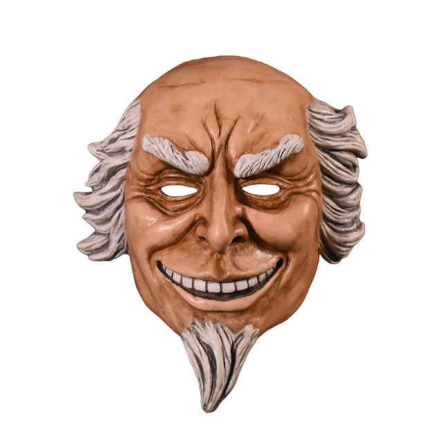 Plastic face mask.  Front view.  Man with wrinkled brow and around eyes, smiling showing teeth, white hair on sides of head, bald on top. white eyebrows and goatee.