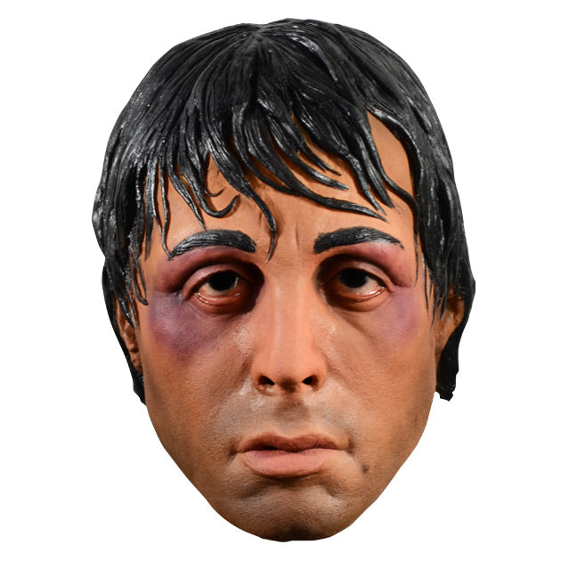 Mask, front view.  Rocky face, black hair appears wet, bruises on both eyes.