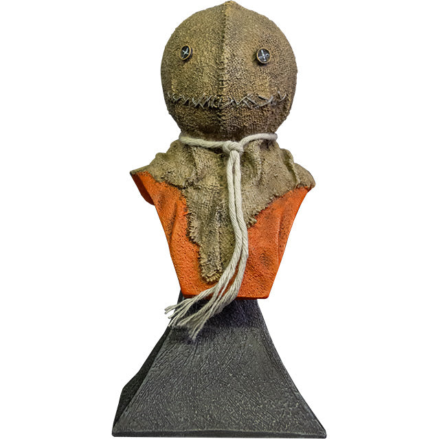 Mini bust. Front view. Trick r' Treat Sam bust, head shoulders and upper chest. Head is a stitched burlap sack, Button eyes, stitched mouth, rope tied around neck, orange shirt. Set on gray stone textured base.