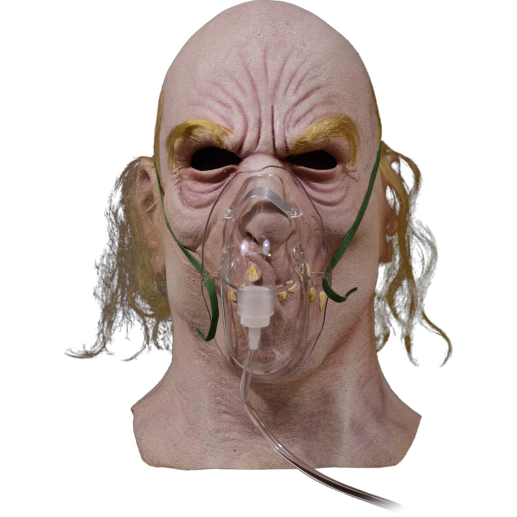 Mask, head and neck. Bald man, long blond hair on sides and back, blond eyebrows, wrinkled skin, wearing oxygen mask.