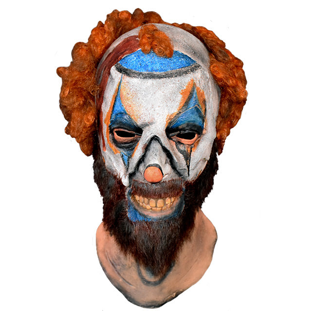 Mask, head and neck, front view.  Disheveled clown mask, sparse curly red hair, white clown makeup, blue triangles painted around eyes, blue around mouth, menacing grin, beard and moustache.