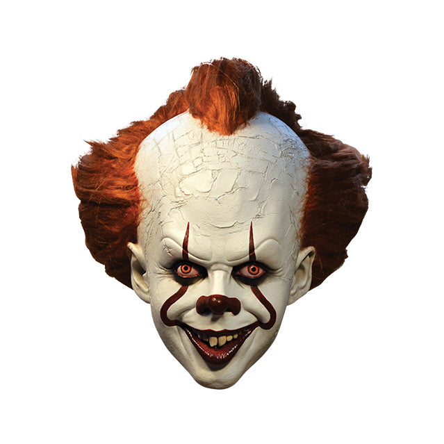 Mask, front view.  IT clown face, red hair, white cracked skin, large forehead, red eyes and nose, dark lips, creepy smile with crooked buck teeth.