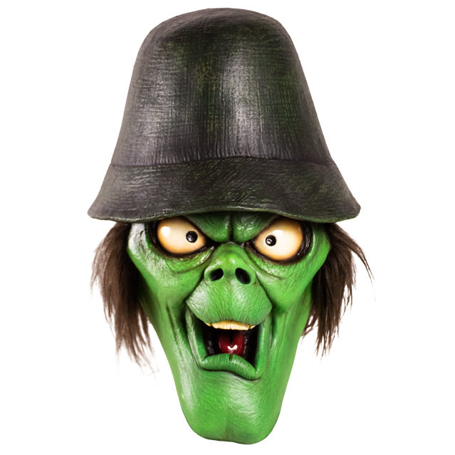 Mask, front view.  Green face with elongated chin, big white eyes, bushy brown hair, wearing a black hat.