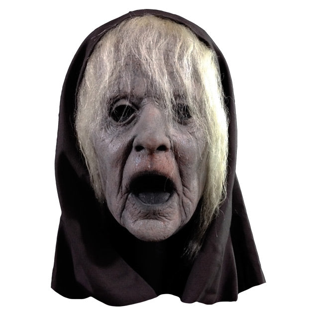 Mask, front view.  Long white hair, wrinkled grayish skin, wide open mouth.  Wearing black hood.