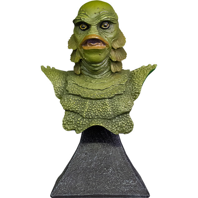 Mini bust, front view. Head, shoulders and upper chest of green scaly fish-man, yellow eyes, large lips, no nose. Set on gray stone textured base.
