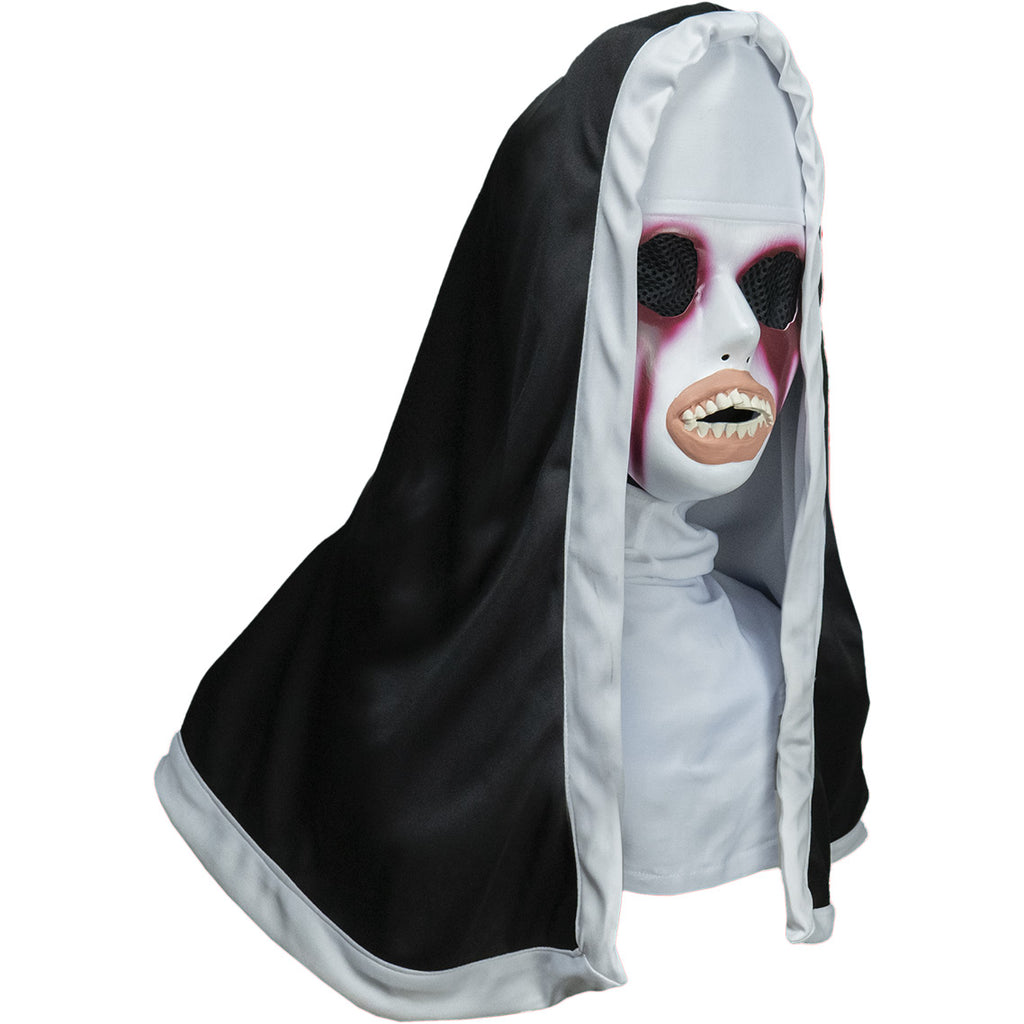 Plastic face mask and nun habit, head, neck and shoulders. Right view. White face, large black mesh covered eye holes, painted in dark red around eyes and dripping down face. Distorted mouth with large peach-colored lips, large crooked teeth. Wearing white trimmed black nun's habit over white head covering and shirt top