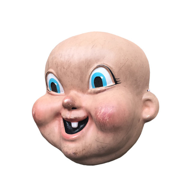 Plastic mask, left side view. Bald, pink baby-like dirty face, large cartoonish blue eyes, mouth smiling with one tooth.