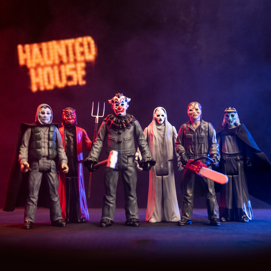 Dramatic lighting, showing full collection of Haunt 3.75 inch figures. Vampire, devil, clown, ghost, zombie and witch. Orange text in background reads Haunted House.