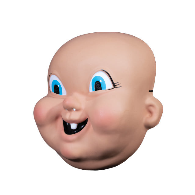Plastic mask, left side view. Bald, pink baby-like face, large cartoonish blue eyes, mouth smiling with one tooth.