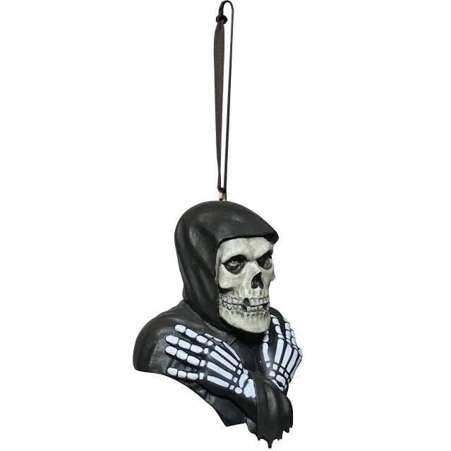Ornament, right side view. Head, shoulders and upper chest. Misfits Fiend, skeleton face and hands wearing black hooded cloak.