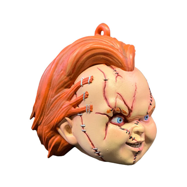 Ornament. right side view. Scarred Chucky head, red hair, blue eyes, scarred and stitched face.
