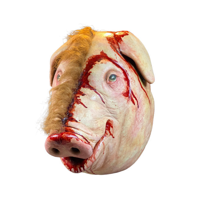 Mask, left side view. Pig face, brown fur on right side, skinned on left side, pink and bloody around ear, nose and mouth