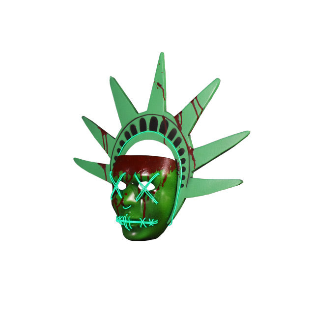 Plastic face mask. Left view. Green mask with nondescript facial features, bloodstains on forehead dripping down face and on green Lady Liberty headpiece. Light up strands of wire threaded around bottom edge of headband, across eyes in an x, in a semicircle under nose, and stitched across mouth.
