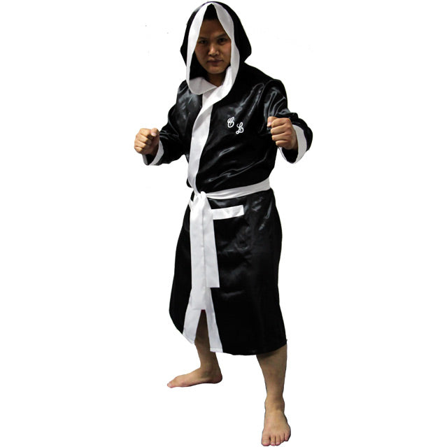 Front view, person wearing hooded black satin robe, white trim and cuffs. Cursive, C L, embroidered on left chest.