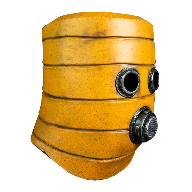 Mask, right side view. Yellow distressed, cylindrical, helmet-like mask. Two silver metallic circles for eyes. Mouth is silver metallic circle with metallic filter.