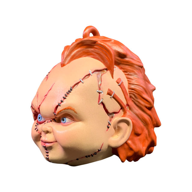 Ornament. Left side view. Scarred Chucky head, red hair, blue eyes, scarred and stitched face. 