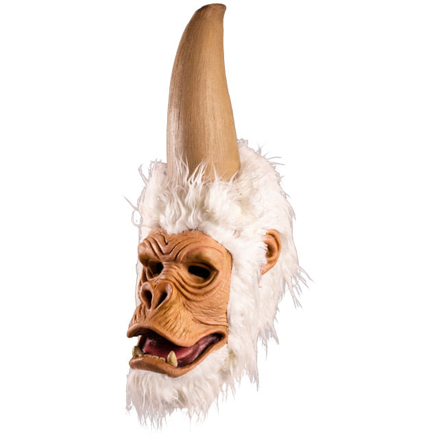 Mask, left side view. Ape-like face, surrounded by white fur, tall elongated upper head that comes to a point.