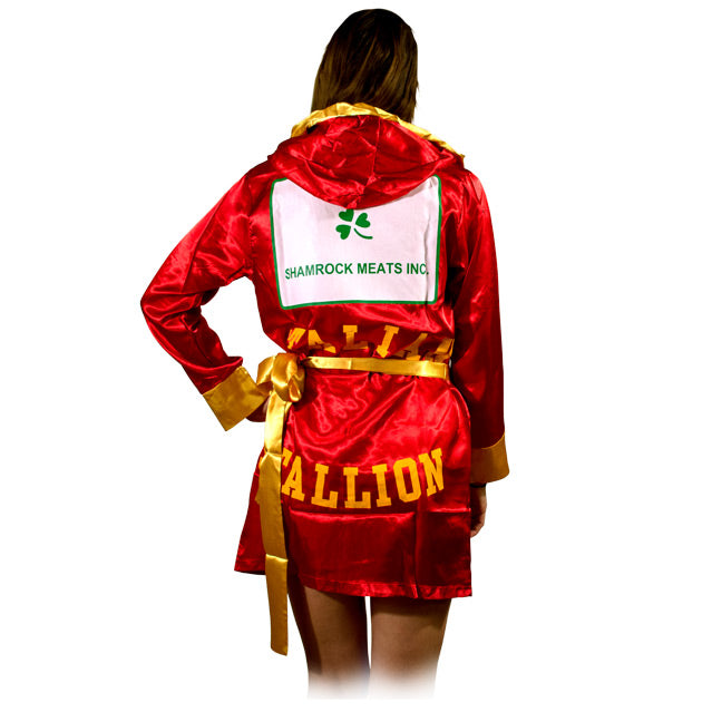 Back view, woman wearing short, red satin robe, gold cuffs. Patch on back, white with green shamrock, green text reads Shamrock Meats Inc. Gold lettering below reads Italian Stallion.