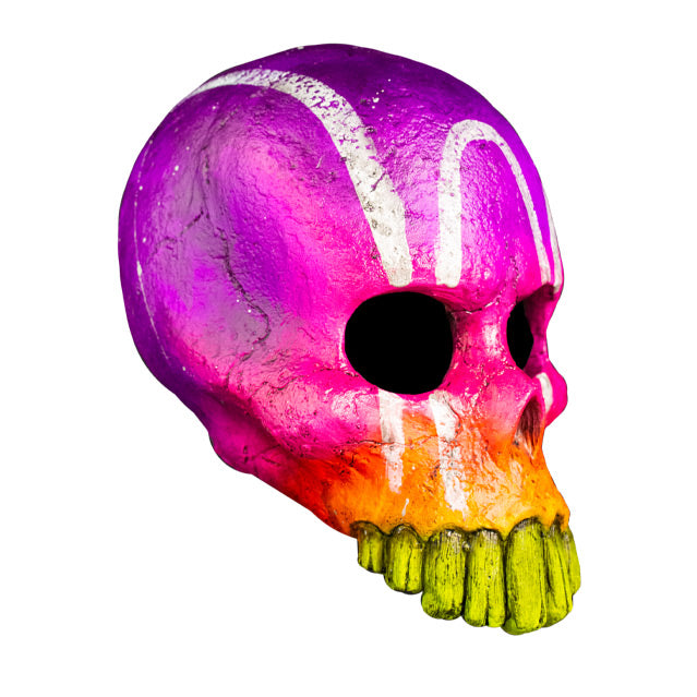 Mask, right view. Multicolor, purple at top blending into pink, orange, then yellow at bottom, White painted vertical lines and arch on forehead. skull face, without lower jaw. Large long teeth.