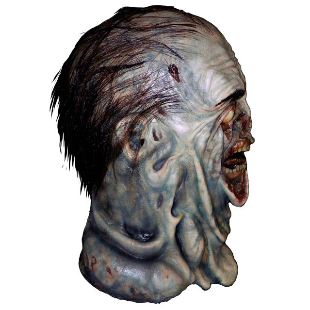Mask, head and neck, right side view. Short black hair, black eyebrows. Blue-gray waterlogged, wrinkled and rotten skin, sagging below white eyes down to neck. Gory under eyes and around mouth. Lips sagging open showing teeth, gums and tongue.