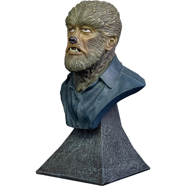 Mini Bust, left view. Wolfman bust, head, shoulders and upper chest. Wolfman face covered in brown fur, with canine-like nose and mouth, wearing dark collared shirt. Set on gray stone textured base.