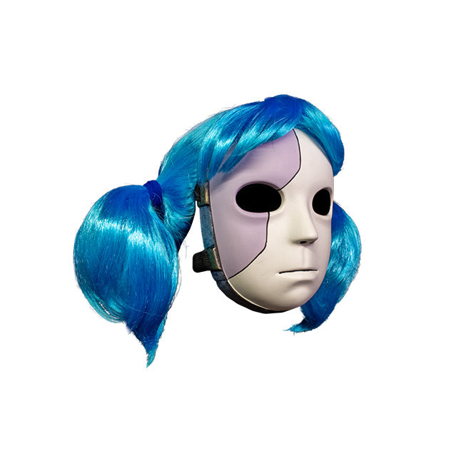 Plastic Mask, right side view. Gray and white face, blank expression, large black eyes. Blue wig in two ponytails. Gray and gold band around border of mask.