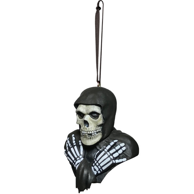 Ornament, left side view. Head, shoulders and upper chest. Misfits Fiend, skeleton face and hands wearing black hooded cloak.