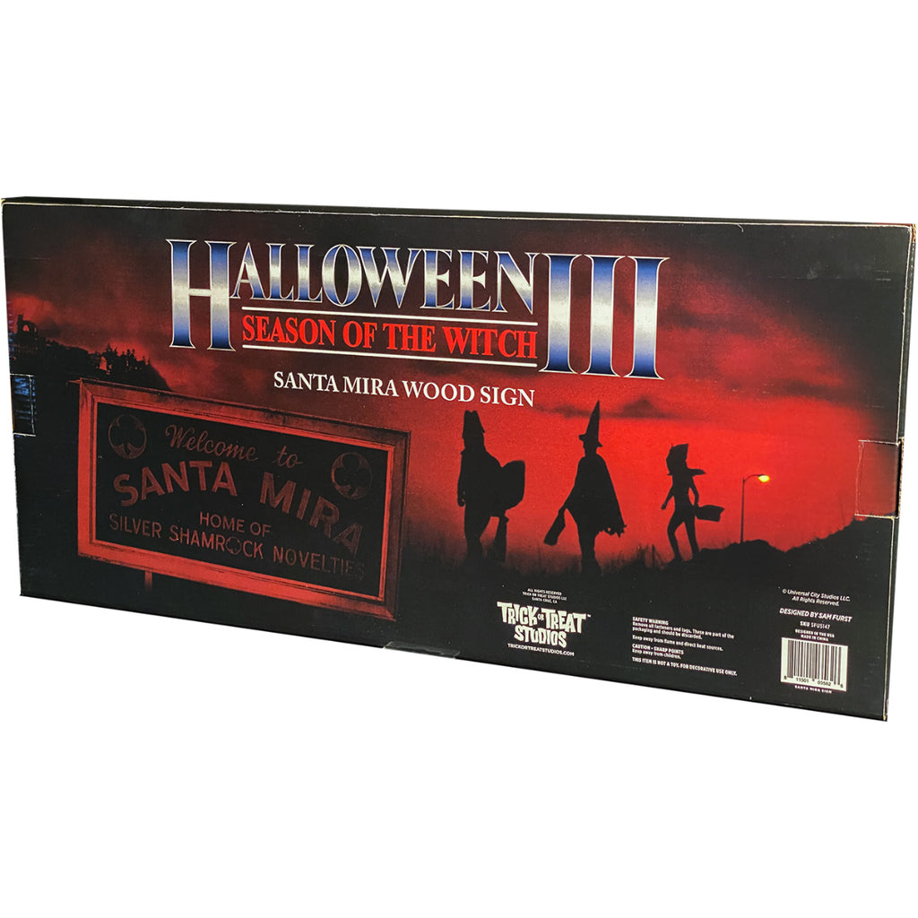 Product packaging, black and red, illustration of the sign and trick or treaters in the background.  Text on box reads Halloween III Season of the Witch, Santa Mira Wood Sign. Licensing and manufacturing information.