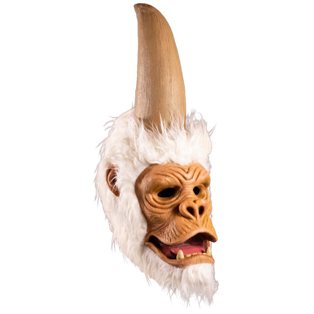 Mask, right side view. Ape-like face, surrounded by white fur, tall elongated upper head that comes to a point.