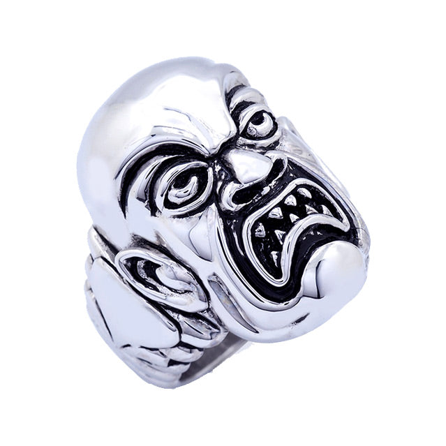 Brass ring, silver plated, overhead, slight right view. Rob Zombie, Phantom Creep face, grimacing man with sharp teeth, design etched in side.