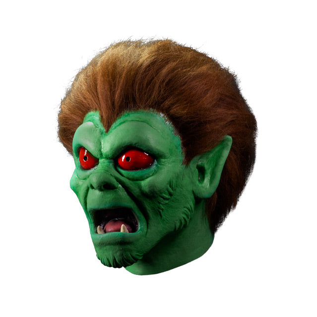 Mask, left side view. Red-brown hair, pointed ears, green skin, red-orange eyes, open mouth showing lower fangs.