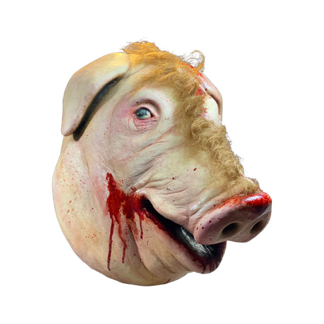 Mask, right side view. Pig face, brown fur on right side, skinned on left side, pink and bloody around ear, nose and mouth