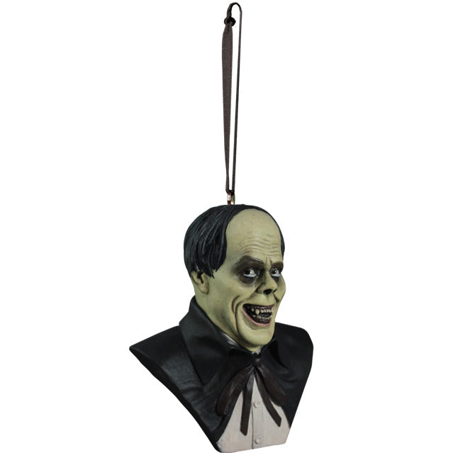 Ornament. Right side view. Phantom of the Opera Bust. Head, shoulders and upper chest of a man with balding black hair, dark circles around eyes, grinning, wearing a white shirt under a black opera cape.