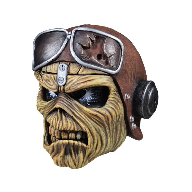 Mask, left side view. Iron Maiden Eddie, black eyes with lightening, wearing aviator helmet and headphones. Scowling mouth.