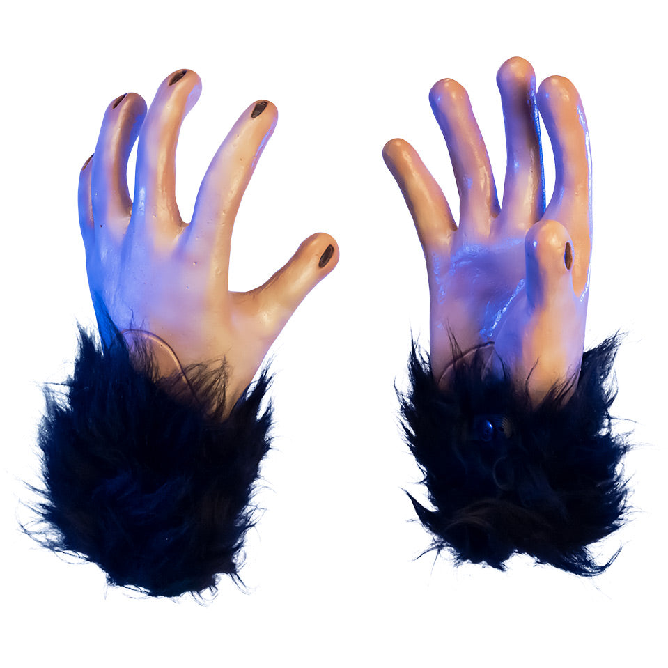 Costume alien hands. Dramatic blue lighting. Back of left hand, palm of right hand black, fur cuffs, black lines for fingernails.