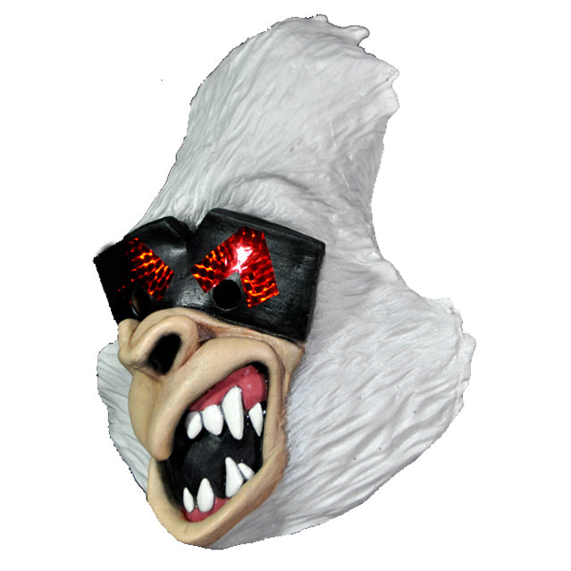 Mask, left side view. Cartoon style white gorilla face, black and red eye mask, gorilla nose and mouth, open showing sharp white teeth and pink gums.