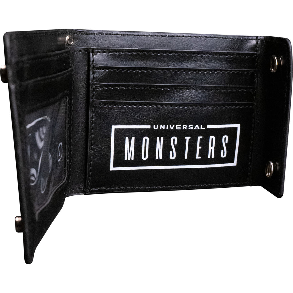 Wallet, open, inside view. Black, 2 silver snaps, Showing several car pockets and clear sleeve.  White text reads Universal Monsters.     
